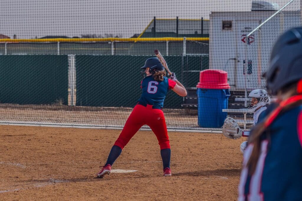 girl batting at softball