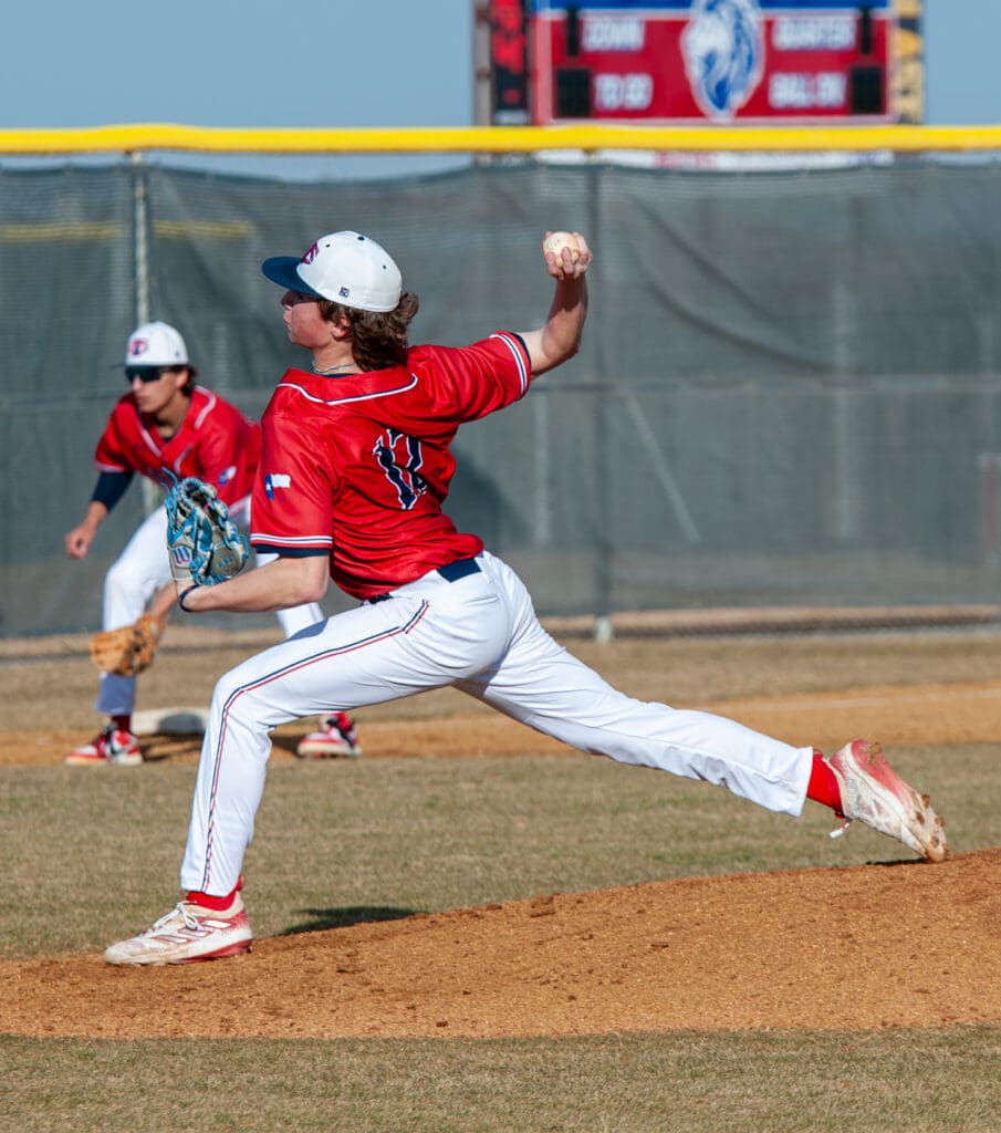 boy throwing at baseball game